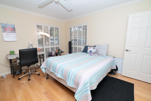 bedroom featuring hardwood / wood-style flooring, ceiling fan, and crown molding