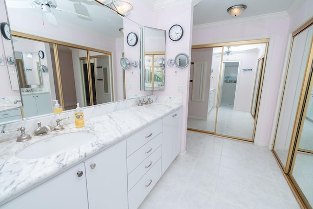 bathroom with ceiling fan, ornamental molding, and vanity