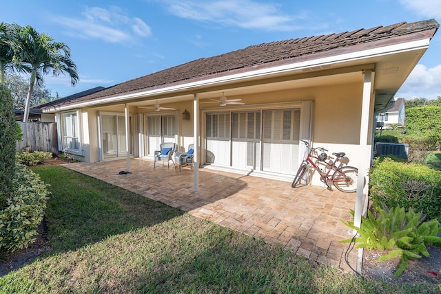 back of property featuring a patio, cooling unit, ceiling fan, and a lawn