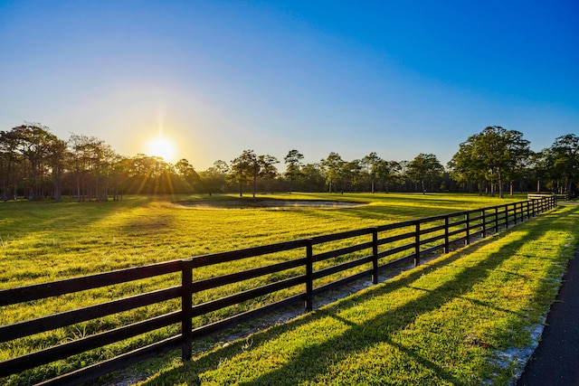 view of gate featuring a rural view and a yard