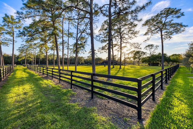 exterior space featuring a rural view and a yard