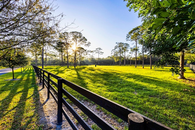 view of community featuring a rural view and a lawn