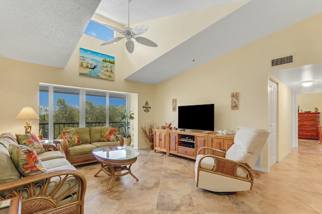 living room featuring a high ceiling, a textured ceiling, and ceiling fan