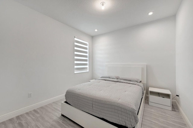 bedroom with light wood-type flooring