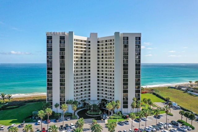 view of property with a view of the beach and a water view