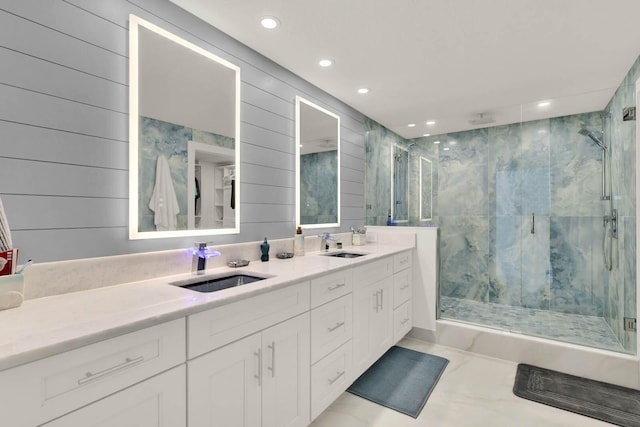 bathroom featuring vanity, wood walls, and walk in shower