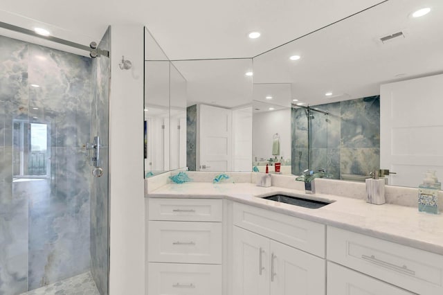 bathroom featuring an enclosed shower and vanity