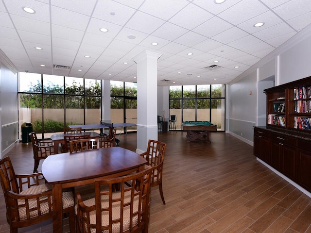 dining room with dark hardwood / wood-style floors, a paneled ceiling, billiards, decorative columns, and floor to ceiling windows