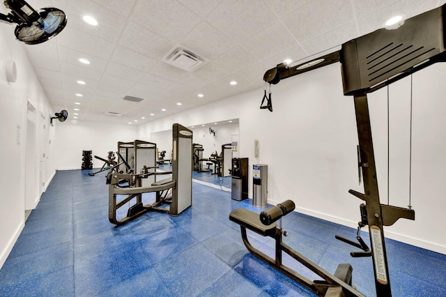 workout room featuring a drop ceiling