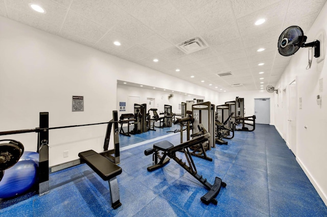 gym with a paneled ceiling