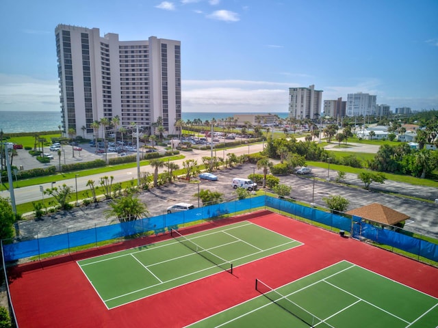 view of tennis court with a water view