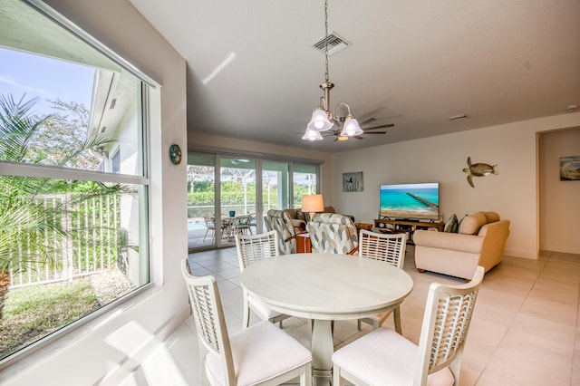 dining space featuring an inviting chandelier, plenty of natural light, and light tile patterned floors