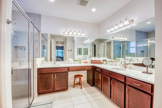 bathroom featuring an enclosed shower, vanity, and tile patterned floors