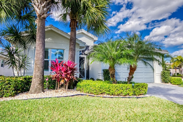 view of front of house with a garage and a front yard