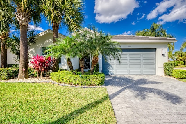 view of front of home featuring a garage and a front lawn