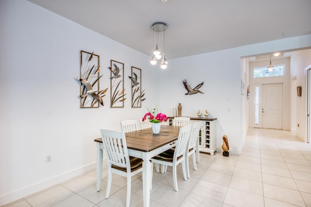 dining space featuring light tile patterned floors