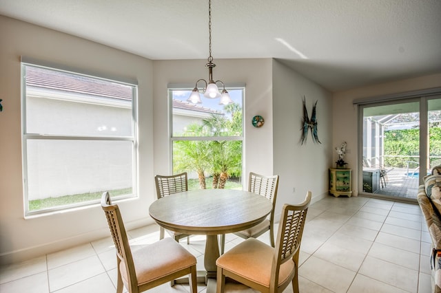 tiled dining area featuring an inviting chandelier