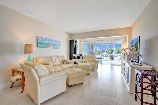 living room with light tile patterned flooring and a textured ceiling