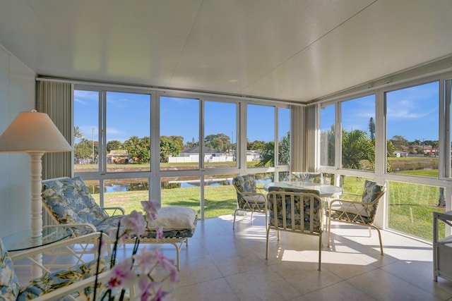 sunroom / solarium with a healthy amount of sunlight and a water view