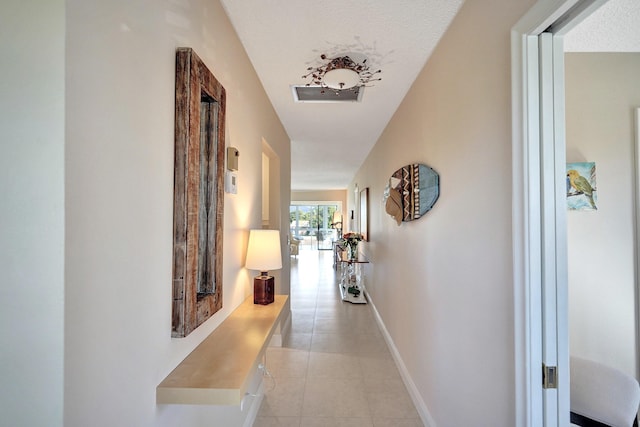 hallway featuring light tile patterned flooring