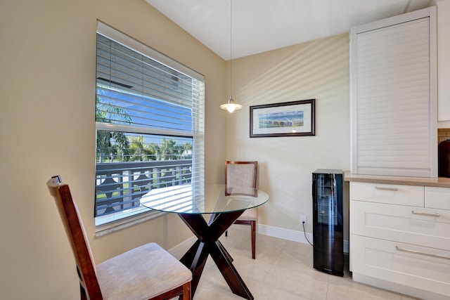 tiled dining space featuring beverage cooler