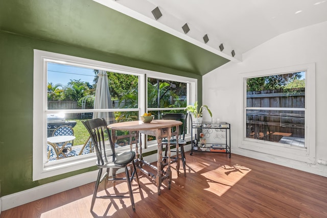 sunroom / solarium featuring vaulted ceiling