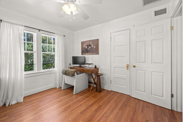 office space featuring ceiling fan and light wood-type flooring