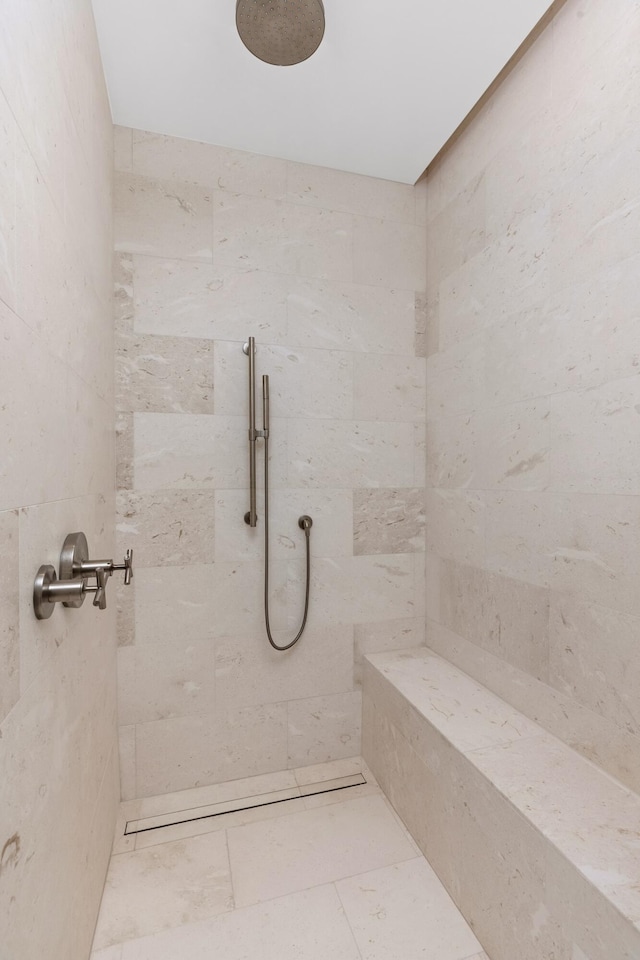 bathroom with tiled shower