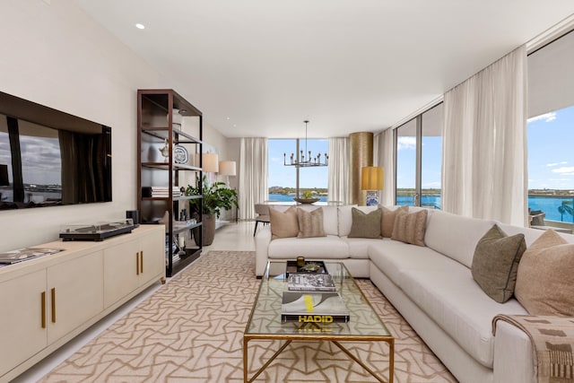 living area featuring an inviting chandelier and a water view