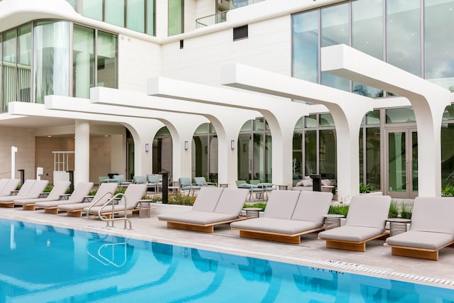 back of house with a patio area, french doors, and a community pool