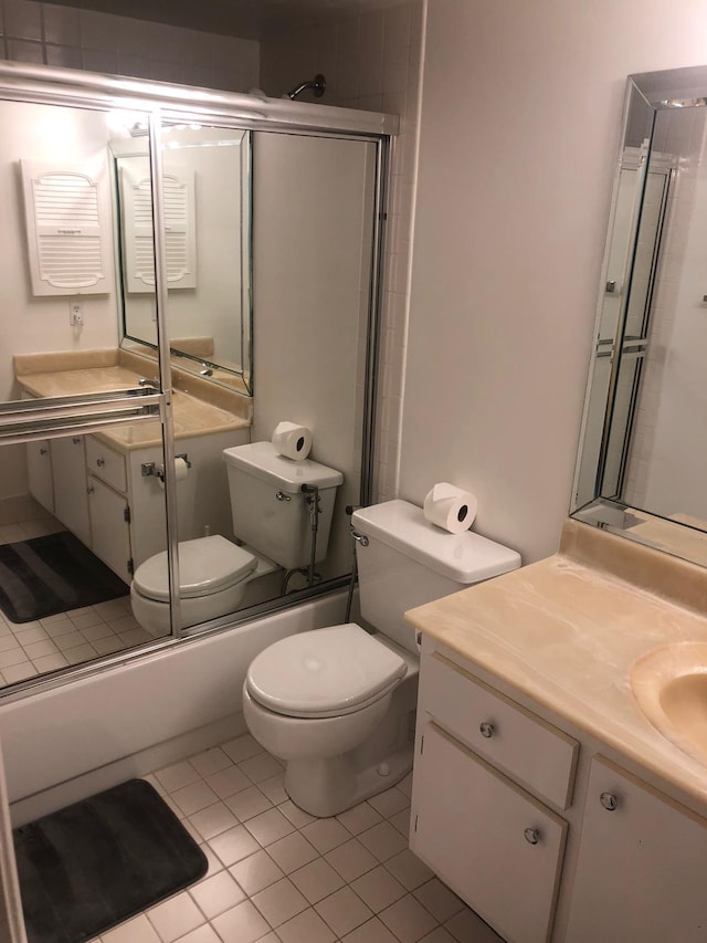 full bathroom with enclosed tub / shower combo, vanity, toilet, and tile patterned flooring