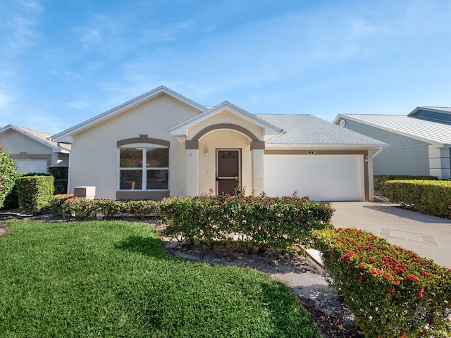 ranch-style home with a garage and a front lawn