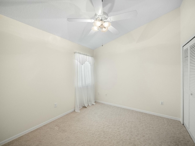 unfurnished bedroom with ceiling fan, light carpet, and a closet