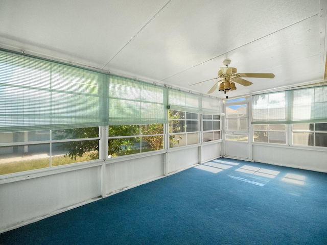 unfurnished sunroom featuring ceiling fan