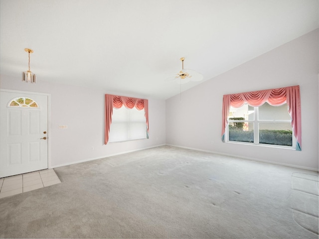 interior space with ceiling fan, lofted ceiling, and carpet