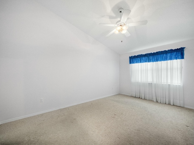 carpeted spare room with vaulted ceiling and ceiling fan