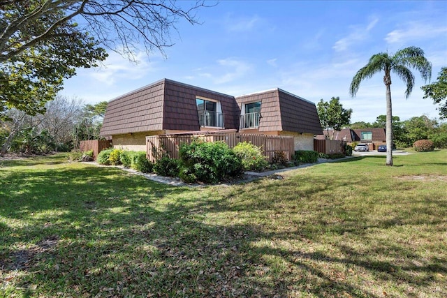 view of side of property with a yard