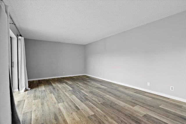 unfurnished bedroom with a textured ceiling and light wood-type flooring