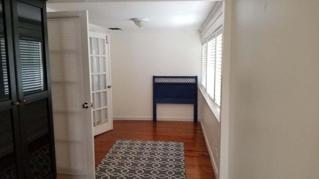 hallway with dark hardwood / wood-style flooring