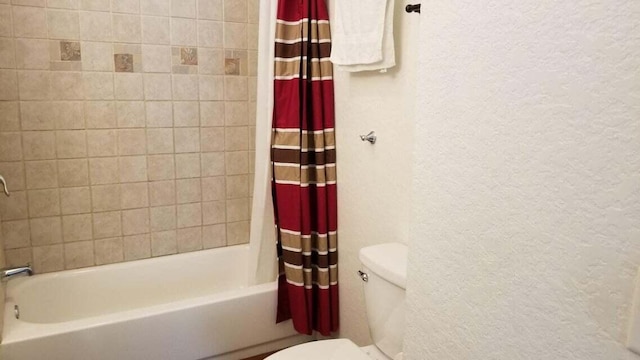 bathroom with shower / tub combo and toilet