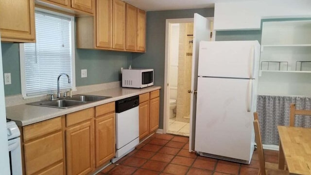 kitchen with white appliances, butcher block counters, dark tile patterned flooring, and sink