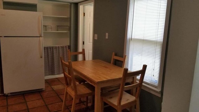 dining area with dark tile patterned floors