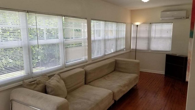 living room featuring plenty of natural light, dark hardwood / wood-style flooring, and a wall mounted AC