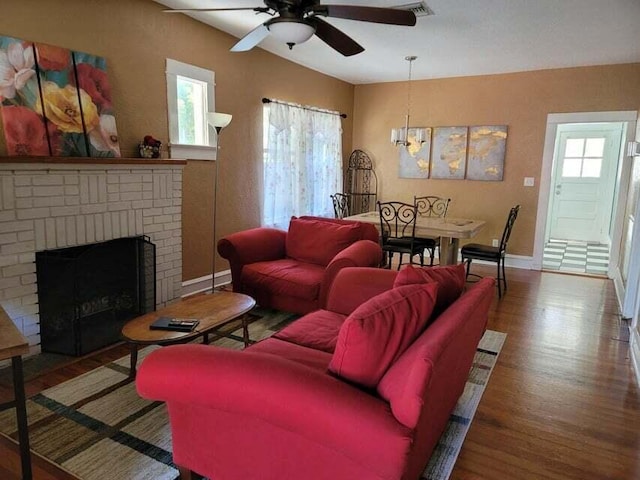 living room with ceiling fan, plenty of natural light, hardwood / wood-style floors, and a fireplace