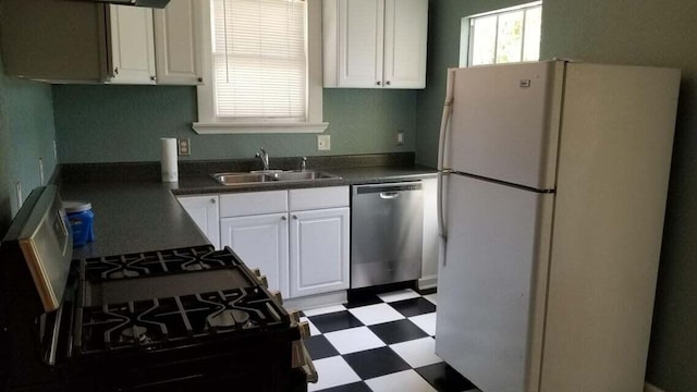 kitchen featuring white cabinetry, sink, white fridge, stainless steel dishwasher, and gas range oven