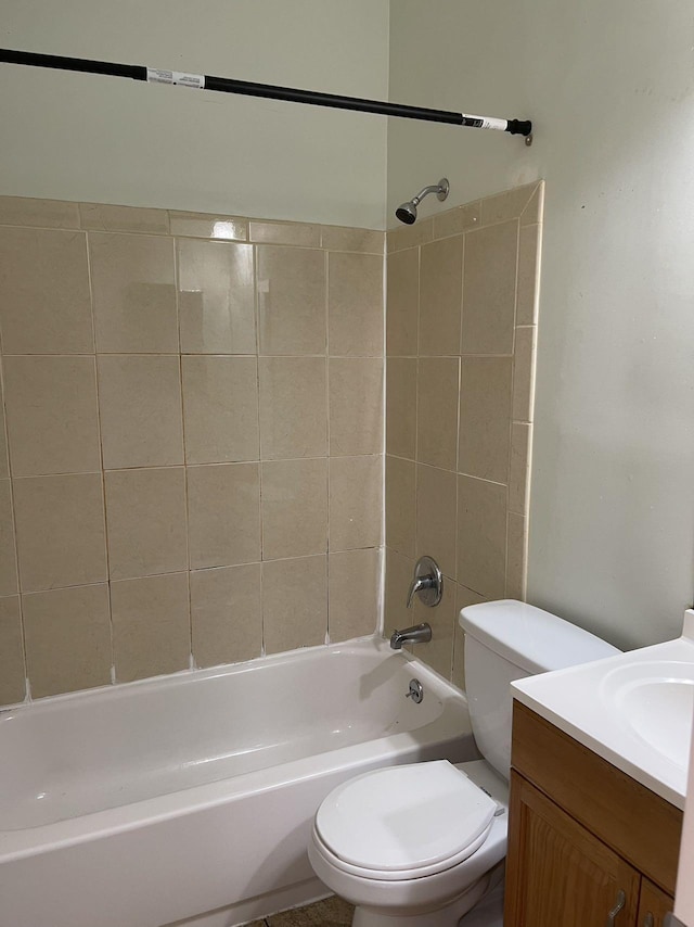 full bathroom with tiled shower / bath combo, vanity, and toilet