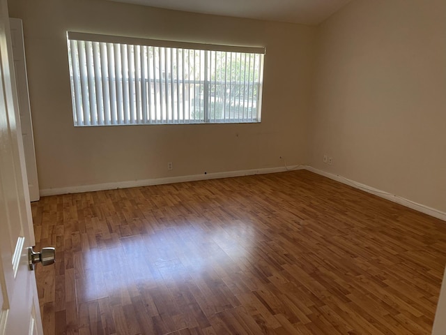 unfurnished room featuring hardwood / wood-style flooring