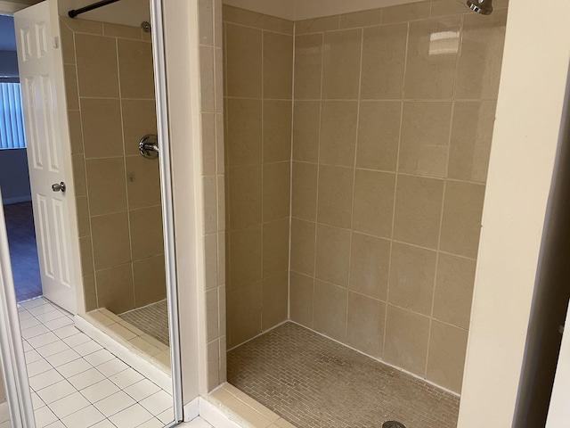 bathroom with tile patterned floors and tiled shower