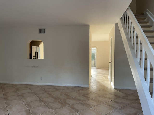 spare room featuring light tile patterned floors