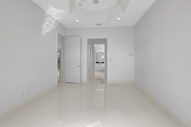 unfurnished room featuring a tray ceiling